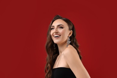 Portrait of happy woman on red background. Space for text