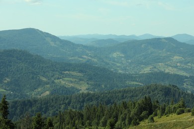 Photo of Picturesque view of mountains with trees under sky