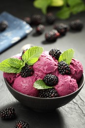 Photo of Delicious blackberry sorbet, fresh berries and mint in bowl on gray textured table