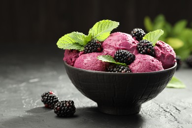 Delicious blackberry sorbet, fresh berries and mint in bowl on gray textured table