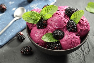 Photo of Delicious blackberry sorbet, fresh berries and mint in bowl on gray textured table, closeup