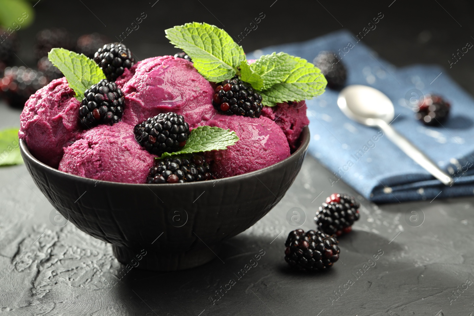 Photo of Delicious blackberry sorbet, fresh berries and mint in bowl on gray textured table, closeup