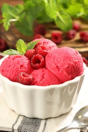 Photo of Delicious raspberry sorbet, fresh berries and mint in bowl on table, closeup