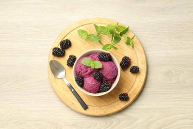 Photo of Delicious blackberry sorbet with fresh berries in bowl and spoon on table, top view