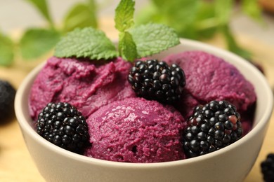 Photo of Delicious blackberry sorbet, fresh berries and mint in bowl on table, closeup