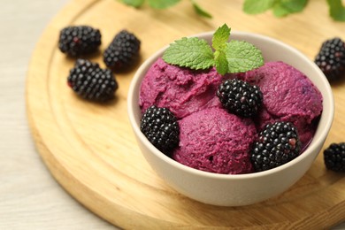 Photo of Delicious blackberry sorbet, fresh berries and mint in bowl on table, closeup