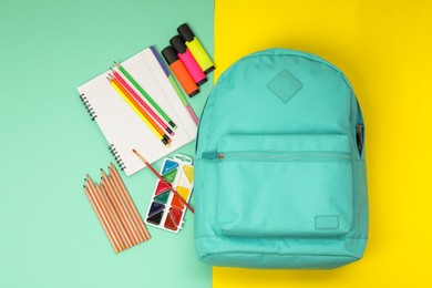 Photo of Flat lay composition with backpack and different school stationery on color background