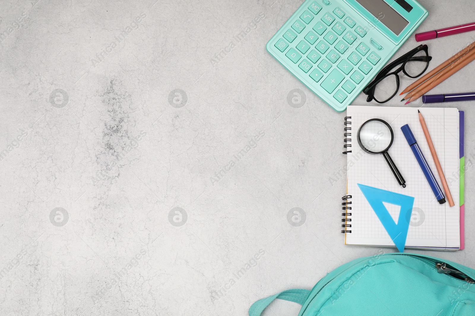 Photo of Flat lay composition with backpack and different school stationery on light grey table, space for text