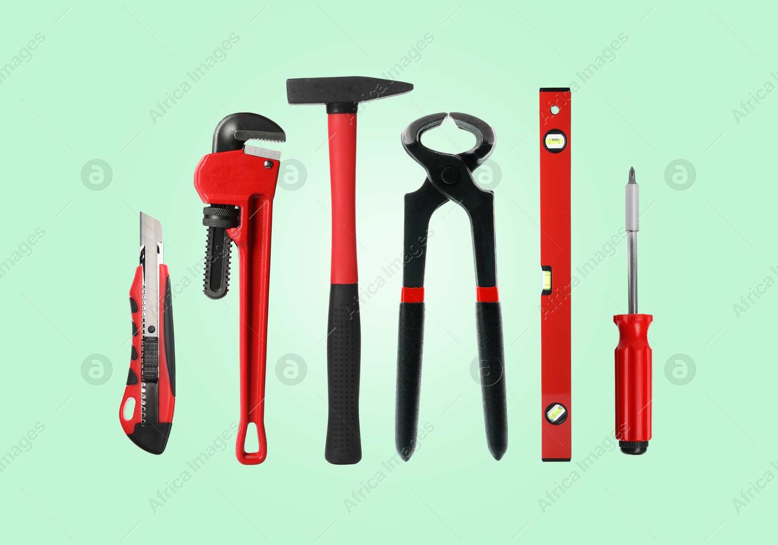 Image of Set of different construction tools on light turquoise background