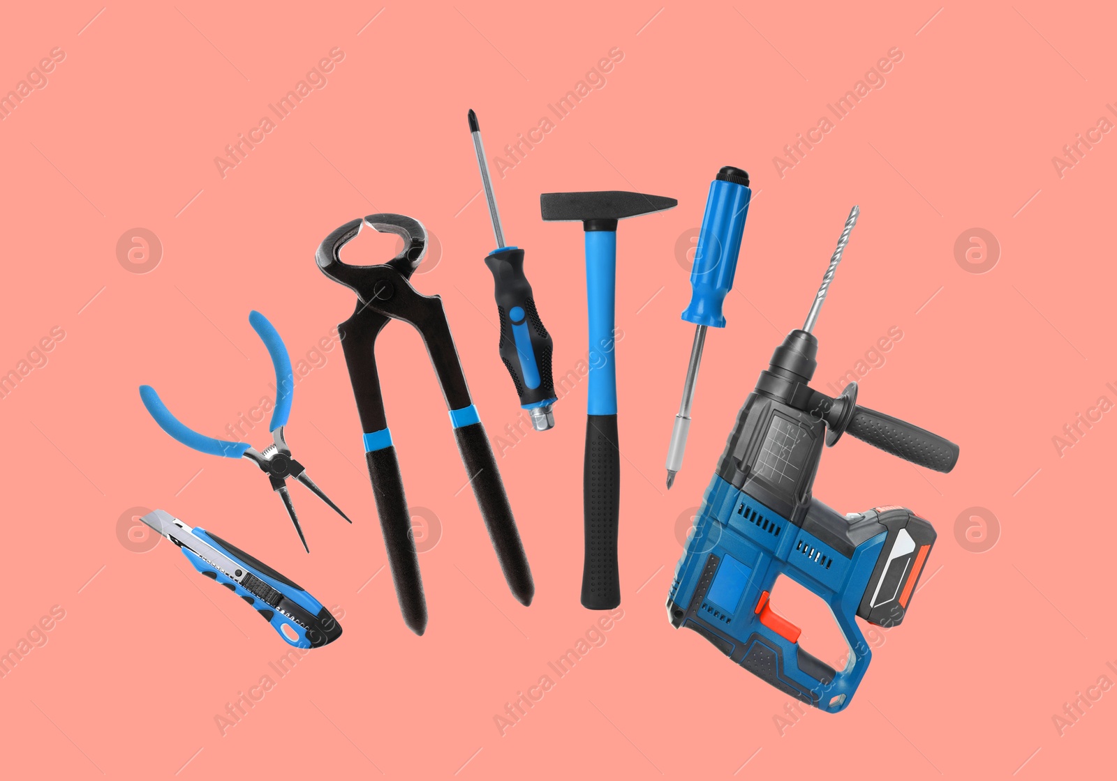 Image of Set of different construction tools on coral background