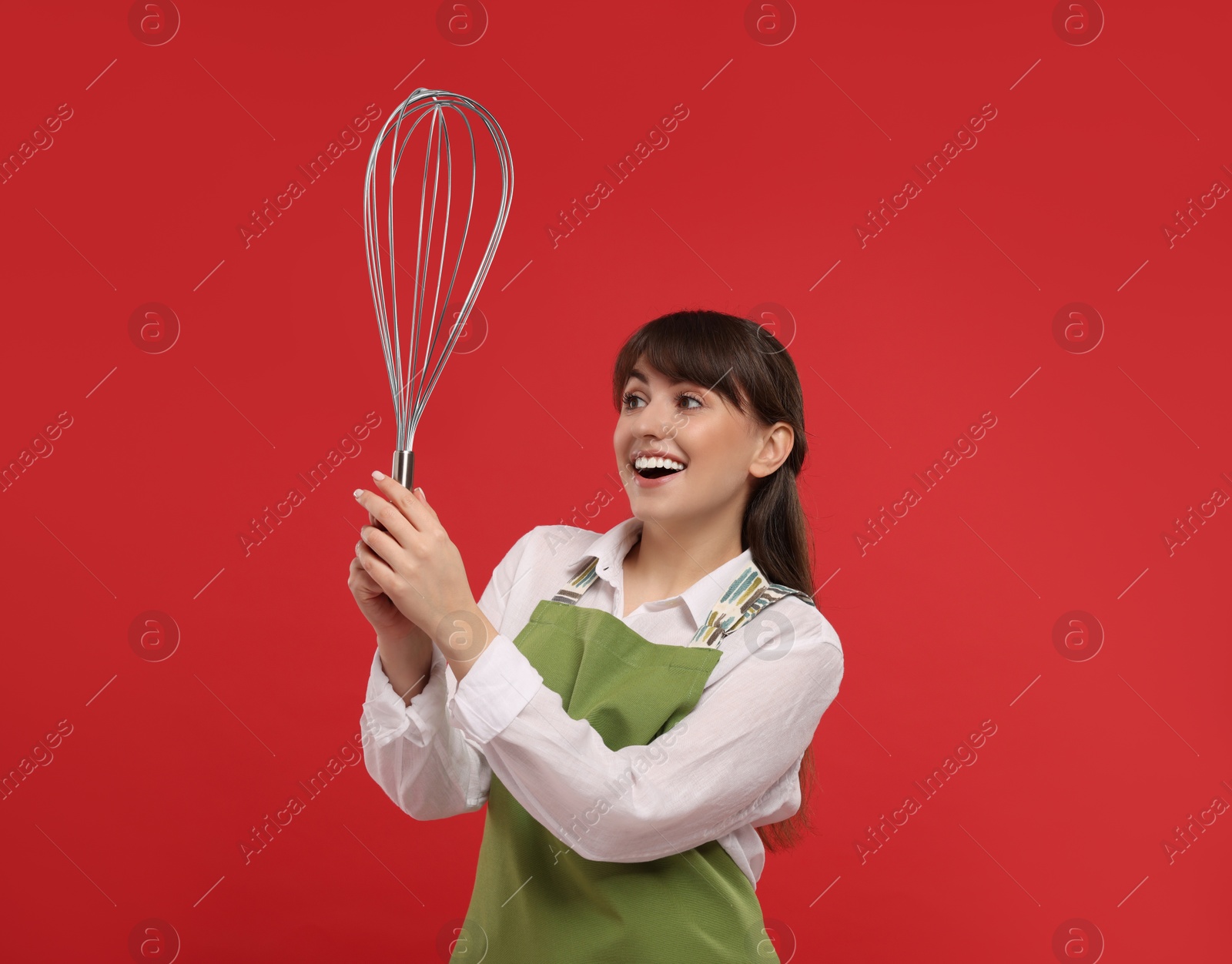 Image of Happy pastry chef with big whisk on red background