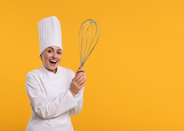 Happy pastry chef with big whisk on orange background. Space for text