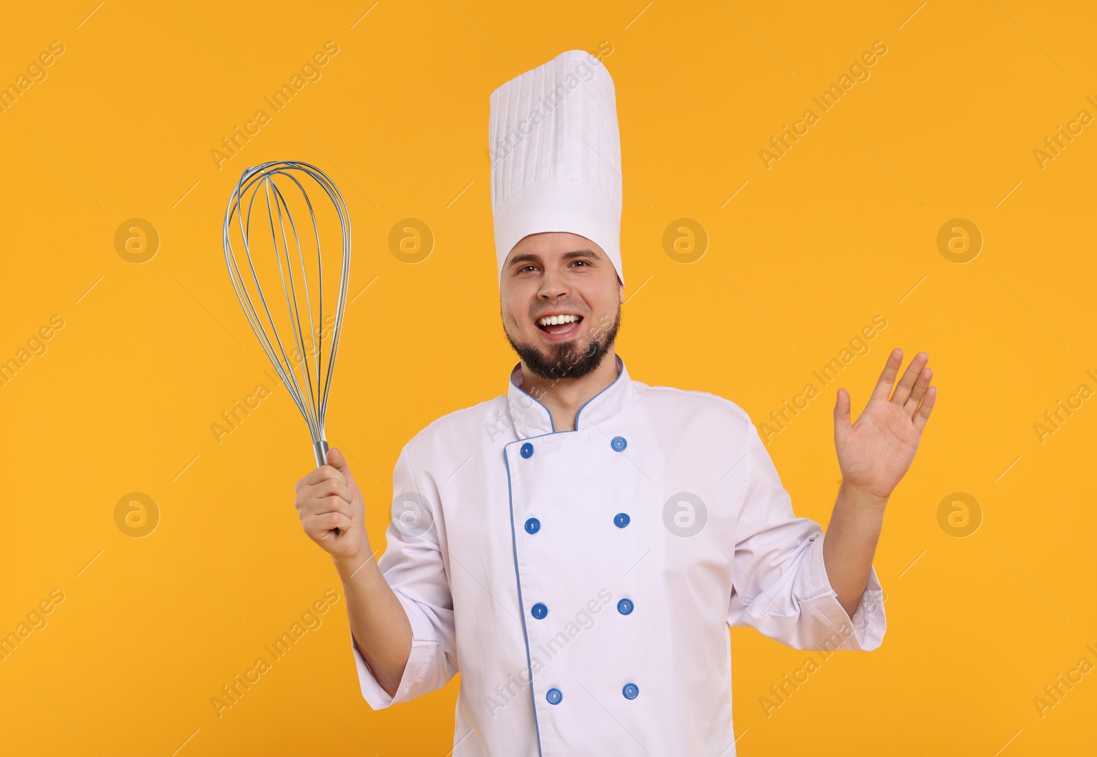 Image of Happy pastry chef with big whisk on orange background