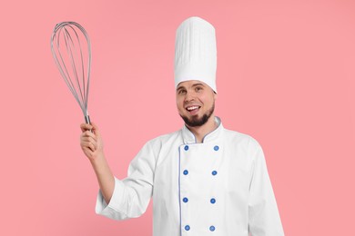 Image of Happy pastry chef with big whisk on pink background