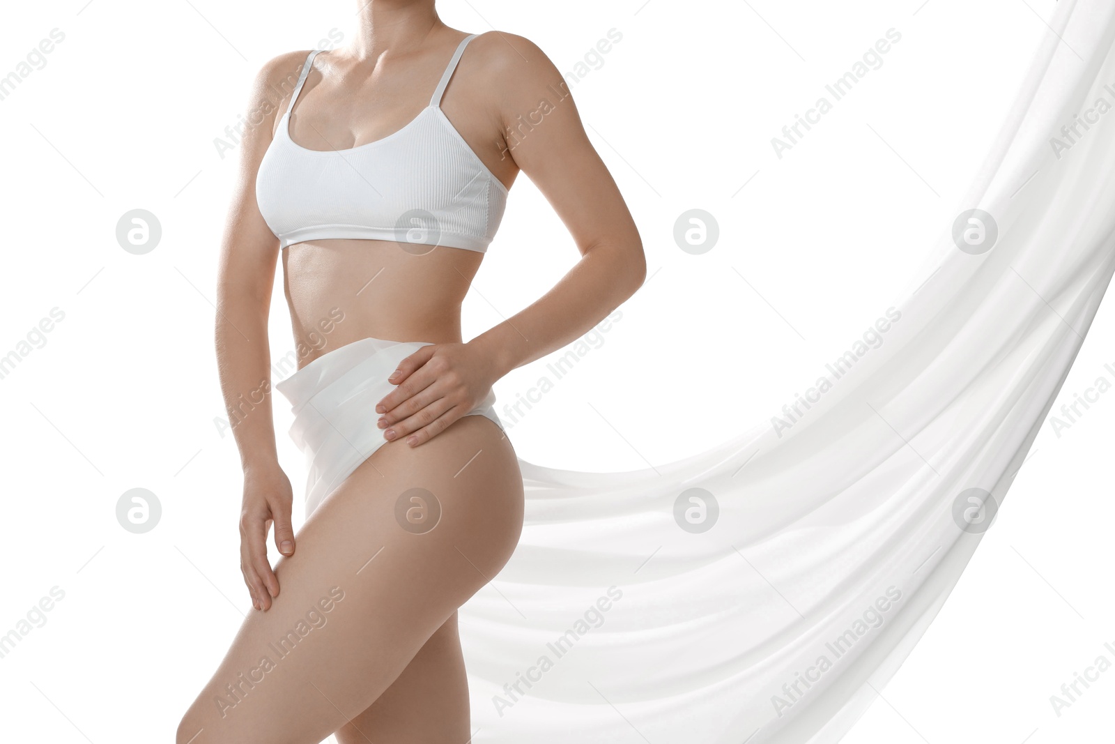 Photo of Woman covering her slim body with silk fabric against white background, closeup