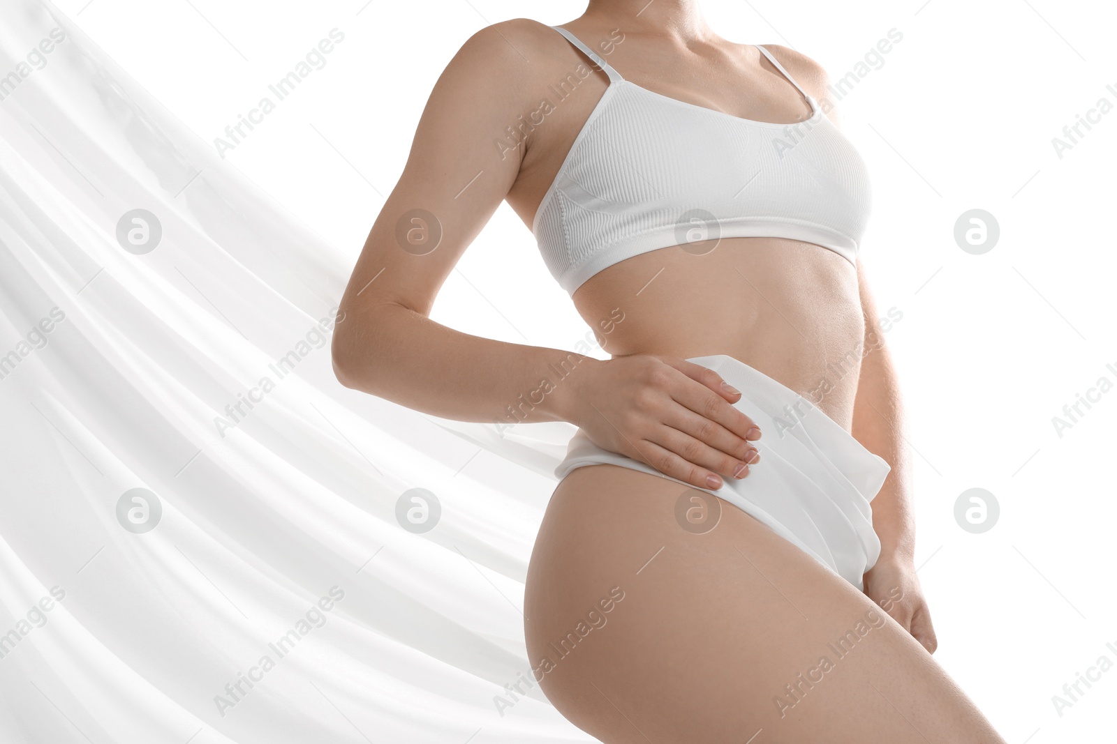 Photo of Woman covering her slim body with silk fabric against white background, closeup