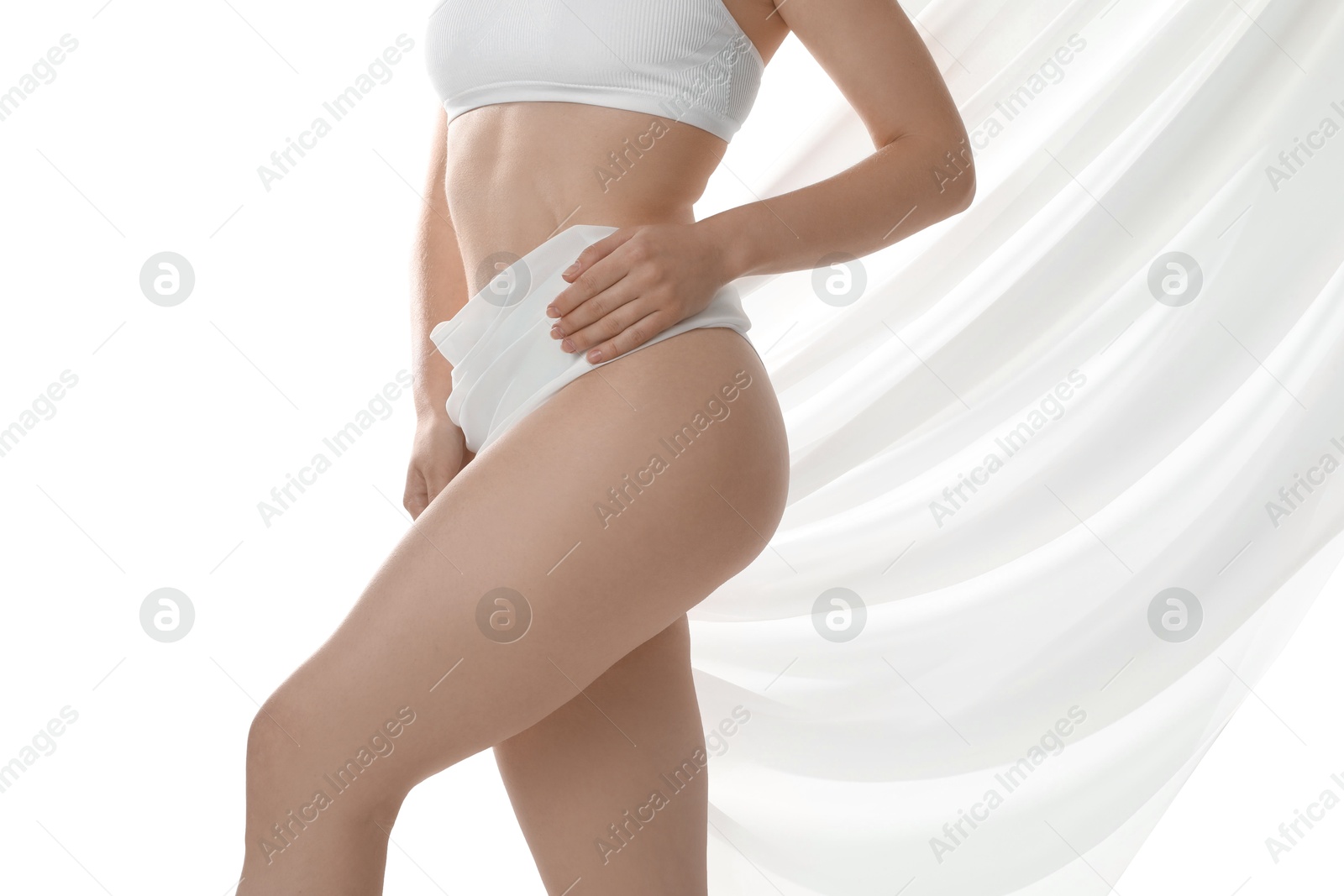 Photo of Woman covering her slim body with silk fabric against white background, closeup