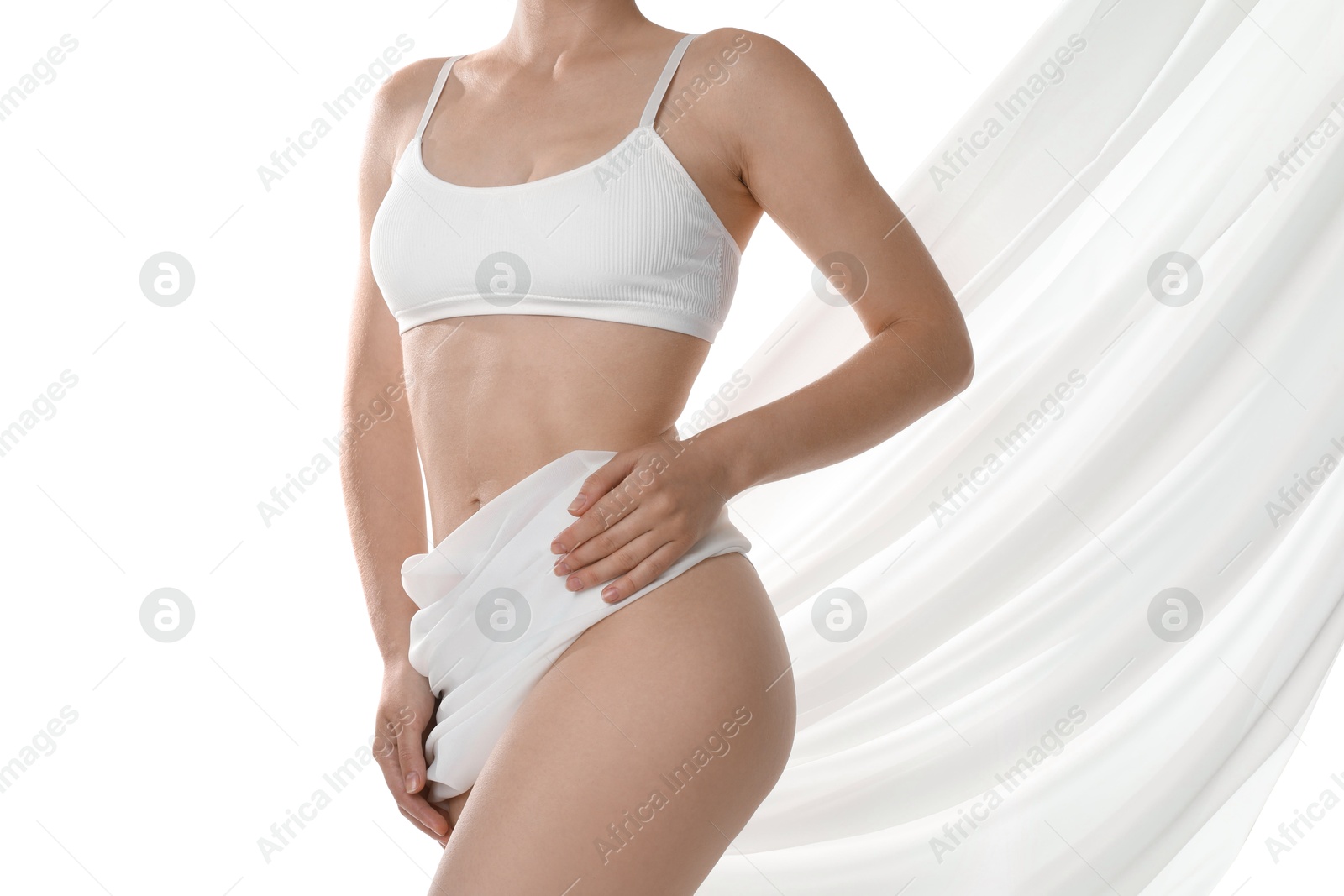 Photo of Woman covering her slim body with silk fabric against white background, closeup