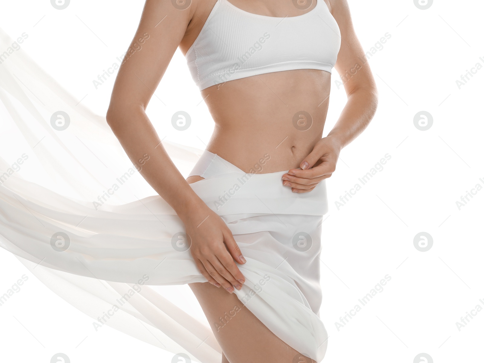 Photo of Woman covering her slim body with silk fabric against white background, closeup