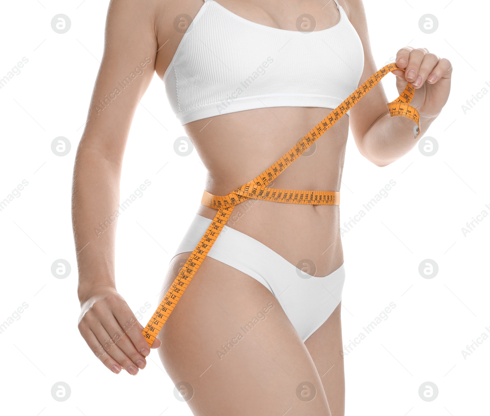 Photo of Woman with measuring tape showing her slim body against white background, closeup