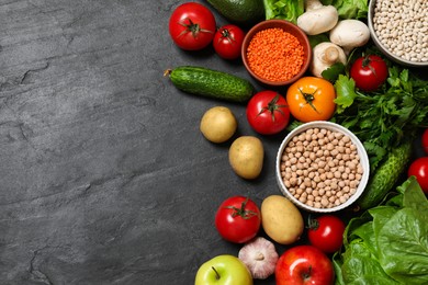 Photo of Healthy vegetarian food. Different vegetables, lentils and apples on dark textured table, flat lay. Space for text