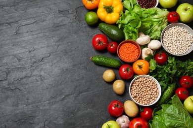 Photo of Healthy vegetarian food. Different vegetables, lentils and apples on dark textured table, flat lay. Space for text