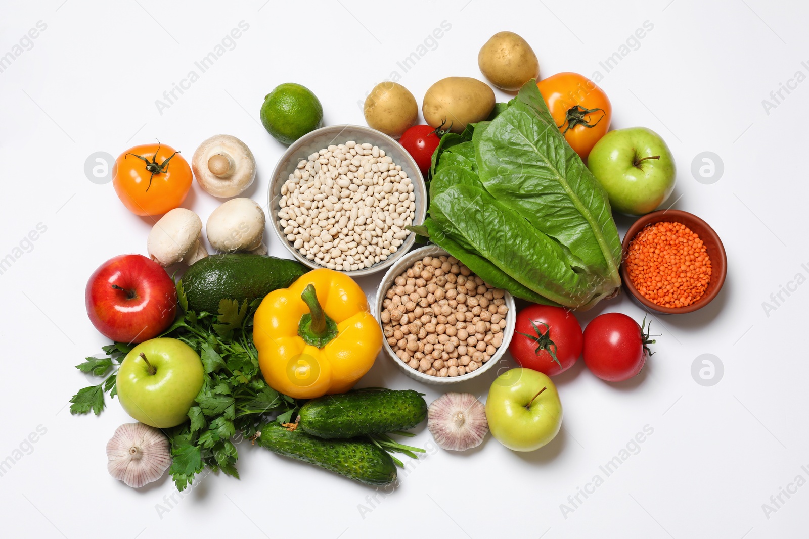 Photo of Healthy vegetarian food. Different vegetables, mushrooms, lentils and fruits on white background, flat lay