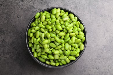 Photo of Raw green edamame soybeans on grey table, top view