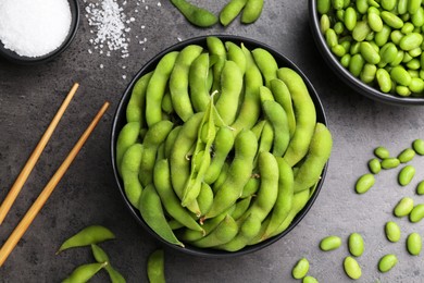 Photo of Raw green edamame soybeans and pods on grey table, flat lay