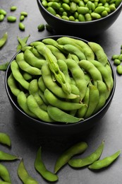 Photo of Raw green edamame soybeans and pods on grey table