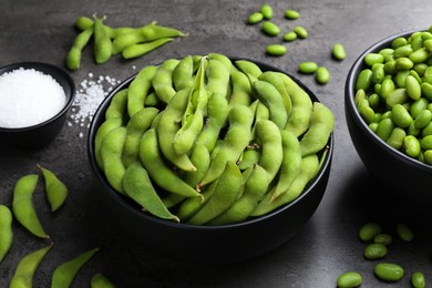 Photo of Raw green edamame soybeans and pods on grey table