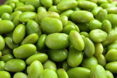 Raw green edamame soybeans as background, closeup