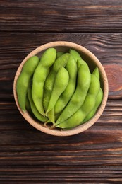 Photo of Raw green edamame pods on wooden table, top view