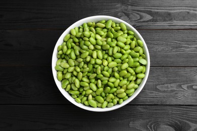 Photo of Raw green edamame soybeans on wooden table, top view