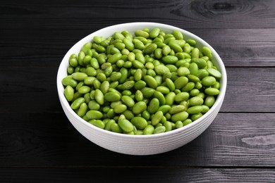 Photo of Raw green edamame soybeans on wooden table