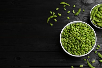 Raw green edamame soybeans and pods on wooden table, flat lay. Space for text