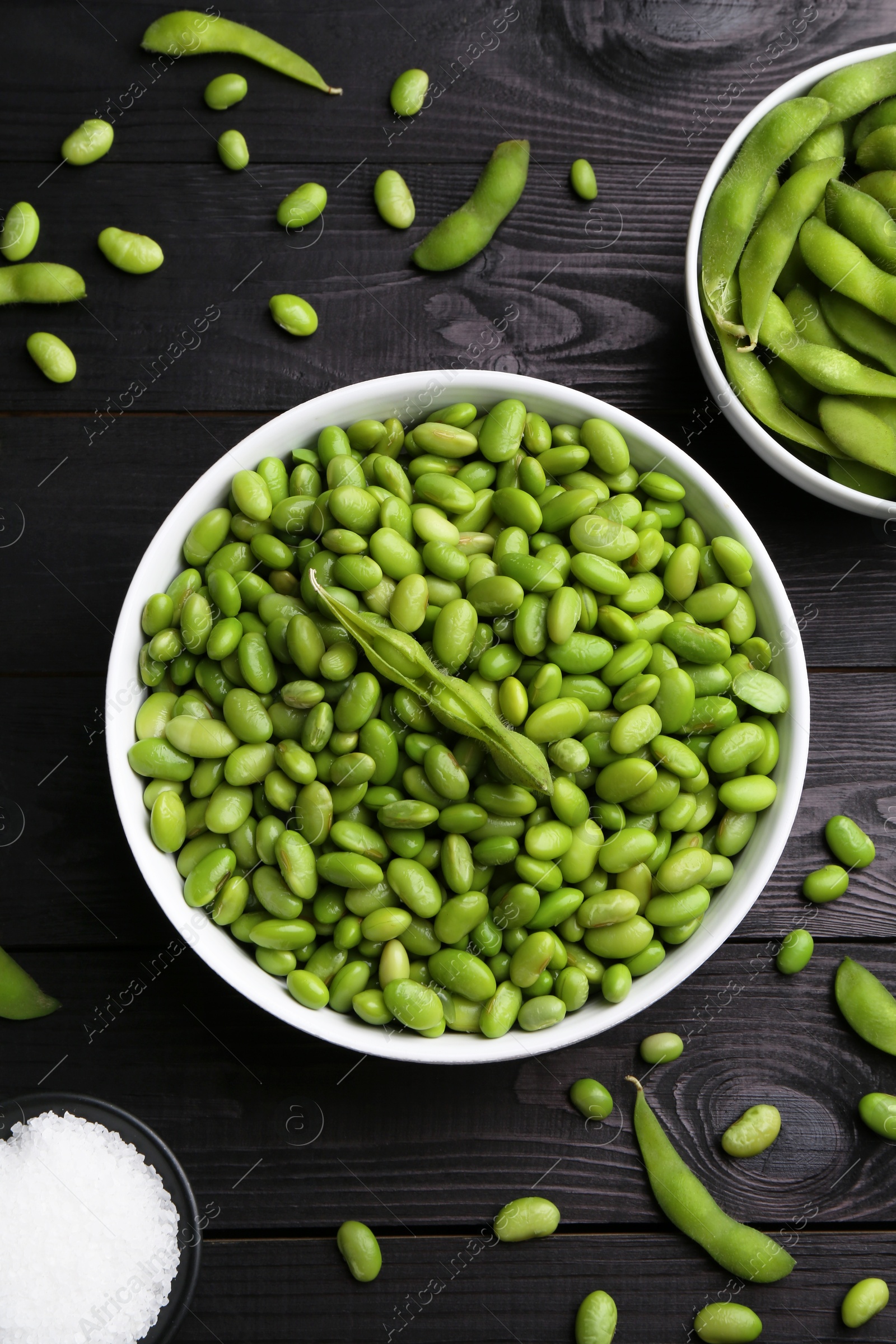 Photo of Raw green edamame soybeans and pods on wooden table, flat lay