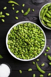 Raw green edamame soybeans and pods on wooden table, flat lay