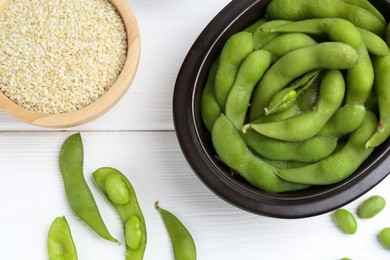 Photo of Fresh edamame pods, soybeans and seeds on white wooden table, flat lay