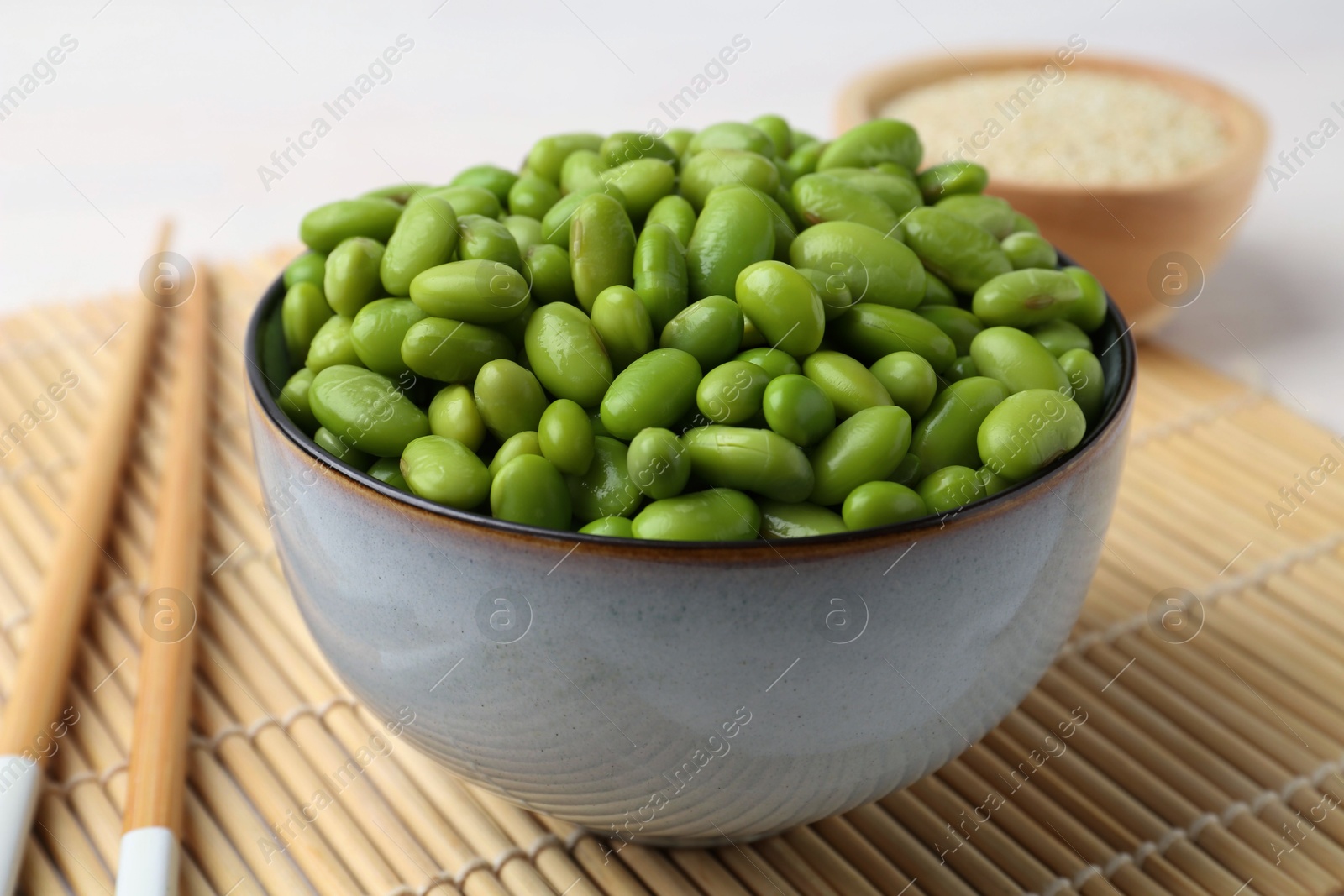 Photo of Fresh edamame soybeans in bowl on table, closeup