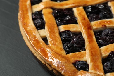 Photo of Tasty homemade pie with blueberries on grey table, closeup