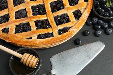 Tasty homemade pie with blueberries served on grey table, closeup