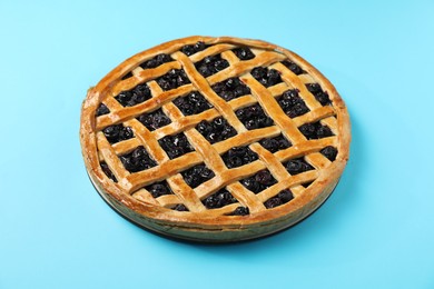 Photo of Tasty homemade pie with blueberries on light blue table