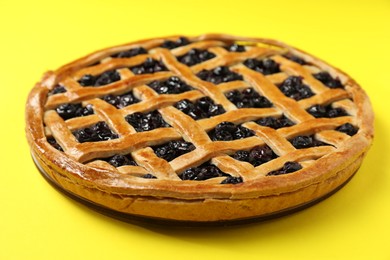 Photo of Tasty homemade pie with blueberries on yellow table, closeup