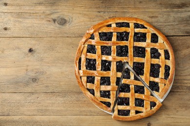 Photo of Tasty homemade pie with blueberries on wooden table, top view. Space for text