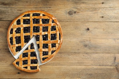 Photo of Tasty homemade pie with blueberries on wooden table, top view. Space for text