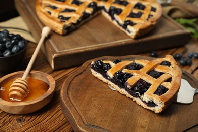 Photo of Tasty homemade pie with blueberries served on wooden table