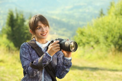 Photo of Photographer with backpack and camera on sunny day. Space for text