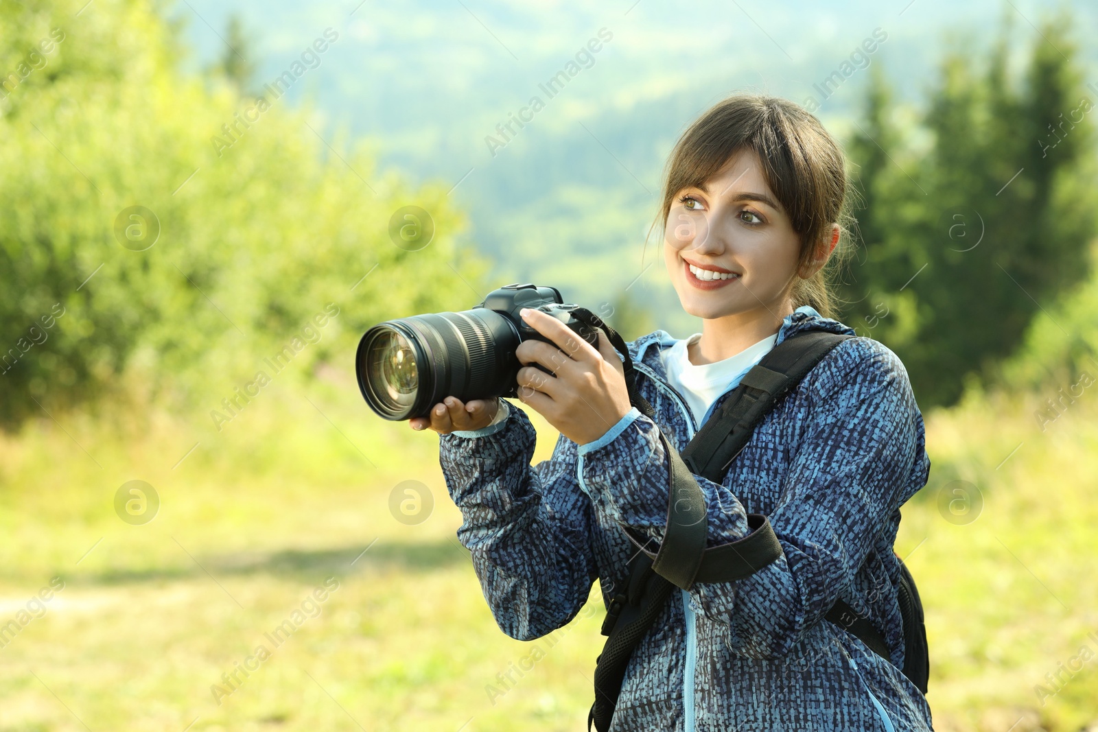 Photo of Photographer with backpack and camera on sunny day