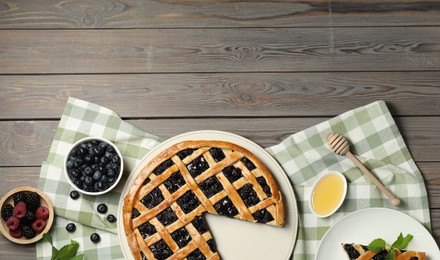 Photo of Tasty homemade pie with blueberries, fresh berries and honey on wooden table, flat lay. Space for text